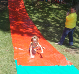 Children on the water slip and slide